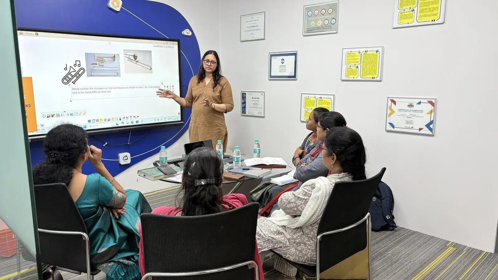 Teacher leading a hands-on professional development session using an interactive classroom display